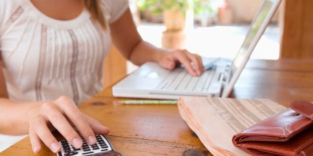 Woman with calculator and laptop