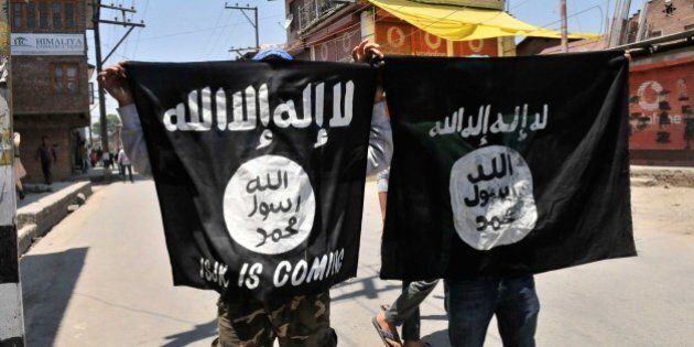 SRINAGAR, INDIA - JUNE 27: Kashmiri protesters displaying the flags of ISIS during a protest against alleged desecration of Jamia Masjid by police personnel yesterday after Friday prayers, on June 27, 2015 in Srinagar, India. Clashes broke out in several parts of downtown Srinagar on Saturday against the alleged desecration of Jamia Masjid by government forces yesterday. Reacting very sharply against police action, Auqaf Jamia Masjid, which functions under Mirwaiz, called for a shutdown in Srinagar followed by Geelani, Malik and Shah. (Photo by Waseem Andrabi/Hindustan Times via Getty Images)