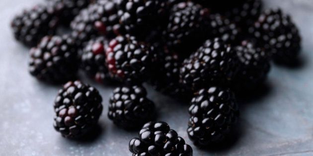 A pile of fresh blackberries on a steel background