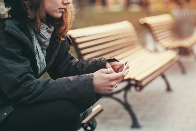 Teenage girl feeling depressed after breaking up with her boyfriend through messages