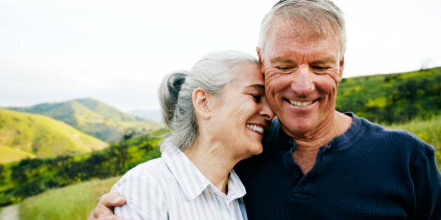 Caucasian couple hugging on hiking trail