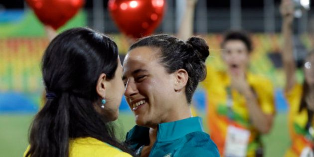 Brazil's Isadora Cerullo, right, shares a moment with her partner Marjorie Enya, after she was asked her to marry her, after the medal ceremony for the women's rugby sevens match at the Summer Olympics in Rio de Janeiro, Brazil, Monday, Aug. 8, 2016. (AP Photo/Themba Hadebe)