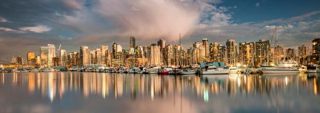 View of Vancouver Canada British Columbia city panorama skyline from Stanley Park in the evening