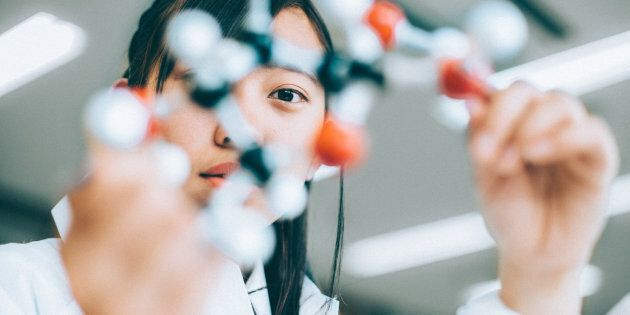 Japanese High School Girl holding a glucose molecular model in the chemistry lab
