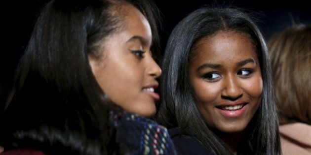 Sasha Obama (R) looks toward her sister Malia as they attend the National Christmas Tree Lighting and Pageant of Peace ceremony on the Ellipse Washington December 3, 2015. REUTERS/Kevin Lamarque