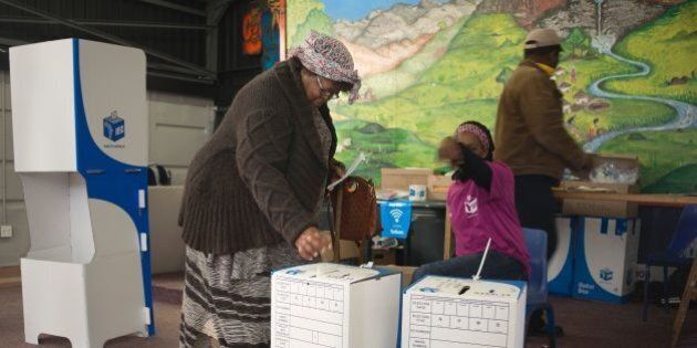 A woman casts her ballot at a polling station in Imizamo Yethu, an impoverished informal settlement in Hout Bay, during South African municipal elections, on August 3, 2016, in Cape Town. South Africans voted Wednesday in closely contested municipal elections that could deal a heavy blow to the African National Congress (ANC), which has ruled since leading the struggle to end apartheid. Nelson Mandela's former party risks losing control of key cities including the capital Pretoria, the economic hub Johannesburg and coastal Port Elizabeth, according to some polls. / AFP / RODGER BOSCH (Photo credit should read RODGER BOSCH/AFP/Getty Images)