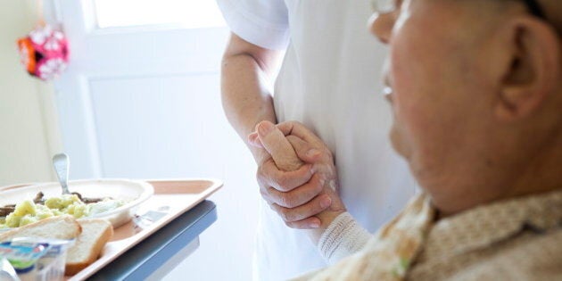 Reportage in Bligny hospital palliative care unit, Briis sous Forges, France. An auxiliary nurse looks after a patient. (Photo by: BSIP/UIG via Getty Images)