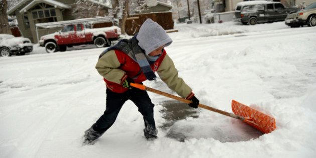 DENVER, CO. - February 26, 2015: Armando Uride 8, making the most of his snow day off from Beach Court Elementary shoveling snow with his sisters. The group made over $90.00 yesterday after school. February 25, 2015 Denver, CO (Photo By Joe Amon/The Denver Post via Getty Images)