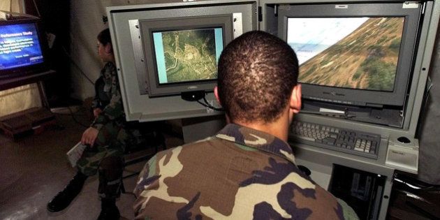 A US soldier pratices with a flight simulator computer using a software which reproduce the visuals of several air military vehicles flying over different environments at the US Army's Task Force Hawk Base in Tirana 05 June 1999. More than five thousand army personnel are deployed with the force, which is assisting NATO's air campaign against Yugoslavia.**DIGITAL IMAGE**