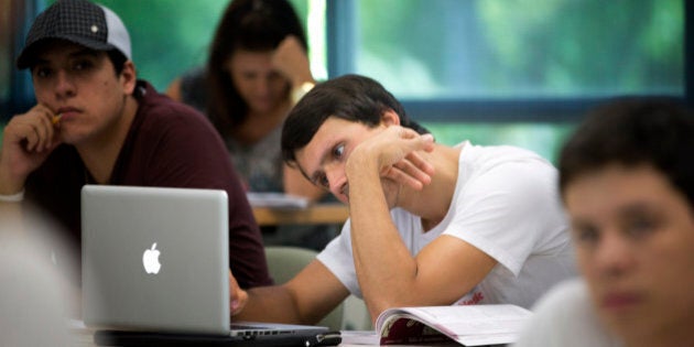 In this Sept. 9, 2013 photo, University of Miami student Gabriel Dias studies the daily lesson plan on his computer during a Spanish language class in Coral Gables, Fla. Learning a foreign language in college is a requisite for many students, but what if you grew up speaking that language, you just canât read it or write it? Thatâs the case for many second-generation immigrant children. Over the last two decades, a growing number of schools have introduced foreign language classes for âheritage learners,â students whose parents may have spoken a language like Spanish at home, but who were formally educated in English. (AP Photo/J Pat Carter)