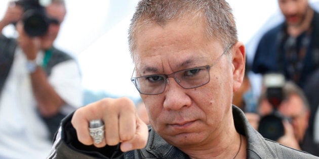 Director Takashi Miike poses during a photocall for the film