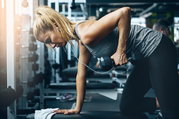 Shot of a sporty woman working out on her own in the gym