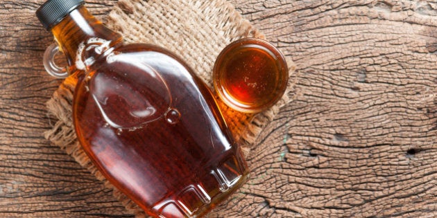 maple syrup in glass bottle on wooden table