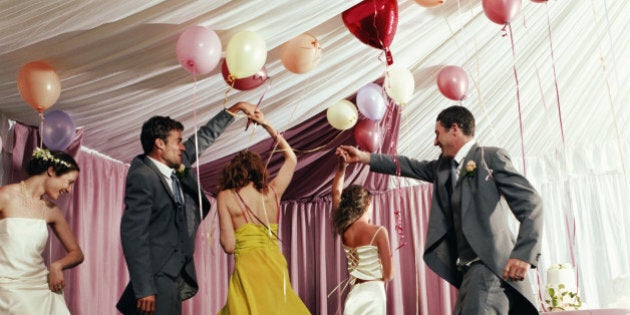 Bridal party dancing in marquee