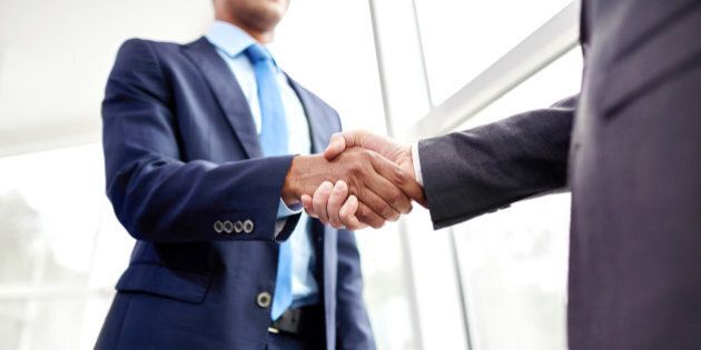Handshake of two business people in the office