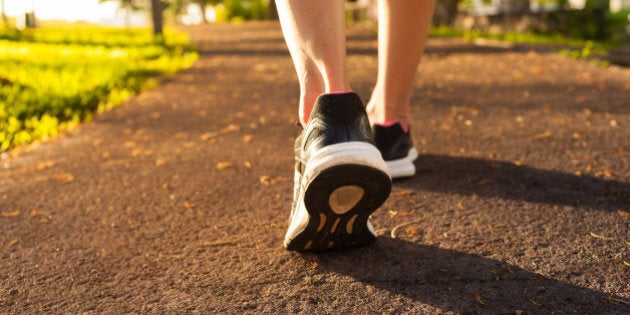 Close up woman walking on a path. Fitness concept.