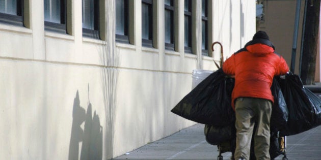 Homeless man with shopping cart