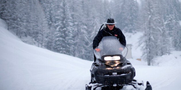 A course worker drives a snowmobile as the second training session of the Women's World Cup Downhill skiing race was cancelled due to heavy snowfall in Cortina D'Ampezzo January 17, 2014. REUTERS/Max Rossi (ITALY - Tags: SPORT SKIING ENVIRONMENT)