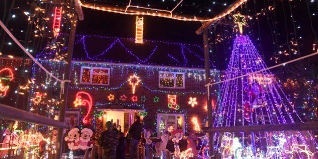Visitors and locals view Christmas displays on dozens of properties that have been decorated in thousands of lights in a tradition that has grown over recent years in the small village of Westfield in Sussex, south east England, December 15, 2016. Picture taken on December 15. REUTERS/Toby Melville
