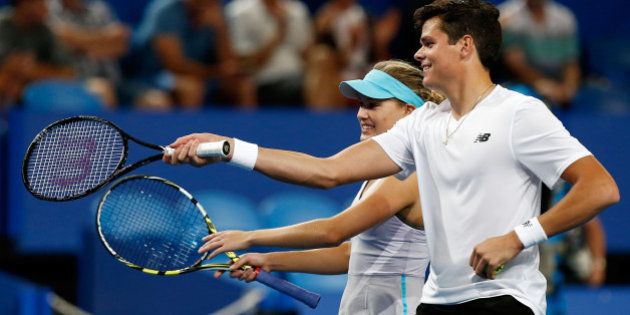 PERTH, AUSTRALIA - DECEMBER 28: Milos Raonic and Eugenie Bouchard of Canada talk inbetween play in the mixed doubles match against Sam Stosur and Bernard Tomic of Australia during day one of the 2014 Hopman Cup at Perth Arena on December 28, 2013 in Perth, Australia. (Photo by Will Russell/Getty Images)