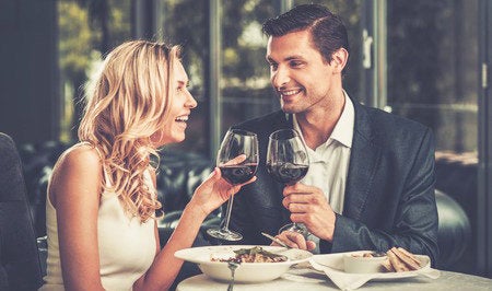 29540064 - cheerful couple in a restaurant with glasses of red wine