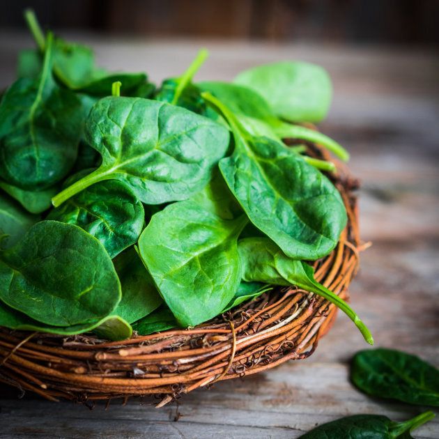 Fresh spinach on rustic wooden backgroundFresh spinach on rustic wooden background