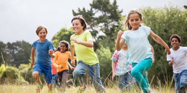 Children, aged 9-10, running together in a park
