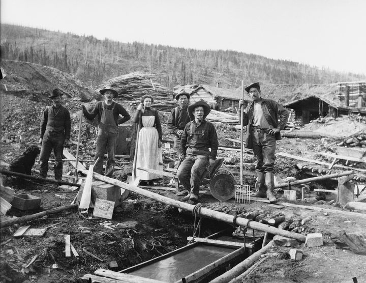 A group of unidentified people sluice for gold during the Klondike gold rush.