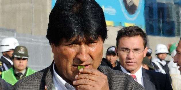 Bolivia's President Evo Morales takes part in an Aymara ritual to acknowledge Pachamama (Mother Earth) before the departure of the reed mace-handmade 18-meter long raft Viracocha III, in La Paz on December 15, 2016. The vessel will join the Viracocha III expedition which will depart from Arica, north Chile, next January 2017 and travel 10.000 nautical miles to Sidney, Australia where it is due to arrive in about six months. US biologist Phil Buck -the man behind the project- aims to demonstrate the ancestral migration between the two continents and reevaluate the indigenous culture that inhabited the villages surrounding the Titicaca Lake -which Bolivia and Peru share- at 3,800 meters above sea level. / AFP / JORGE BERNAL (Photo credit should read JORGE BERNAL/AFP/Getty Images)