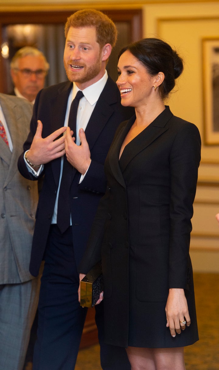 The Duke and Duchess of Sussex talk with other guests as they attend "Hamilton" in London on August 29, 2018.