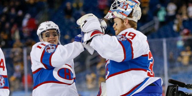 Jan 1, 2016; Foxborough, MA, USA; Montreal Canadiens goalie Mike Condon (39) and Montreal Canadiens right wing Brendan Gallagher (11) celebrate their win over the Boston Bruins after the Winter Classic hockey game at Gillette Stadium. The Canadiens beat the Bruins 5-1. Mandatory Credit: Greg M. Cooper-USA TODAY Sports