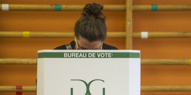 People vote on September 4, 2012 in l'Assomption, Quebec, Canada. Voting started Tuesday in a Quebec election expected to return separatists to power, buoyed by rising frustration with the current leadership and months of student protests over a planned tuition hike. Nearly six million voters in the country's only majority French-speaking province will choose 125 lawmakers. And pre-election polls point to the Parti Quebecois (PQ) coming out on top, though without a full majority. The PQ has been in the opposition since its 2003 defeat by the Liberals, led by Jean Charest, who is only the second person since the 1950s to have served three terms as Quebec premier.AFP PHOTO / ROGERIO BARBOSA (Photo credit should read ROGERIO BARBOSA/AFP/GettyImages)