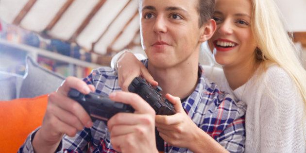 Couple on sofa playing video game