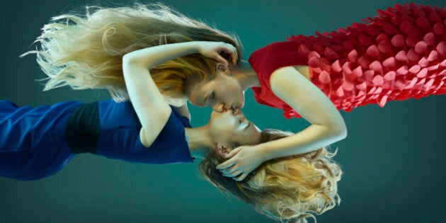 Two women kissing, floating in mid air