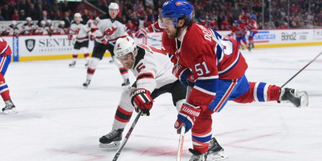 MONTREAL, QC - JANUARY 6: David Desharnais #51 of the Montreal Canadiens controls the puck while being challenged by Adam Larsson #5 of the New Jersey Devils in the NHL game at the Bell Centre on January 6, 2015 in Montreal, Quebec, Canada. (Photo by Francois Lacasse/NHLI via Getty Images)
