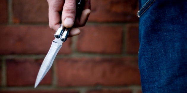 A youth brandishing a knife in the street, UK 2007