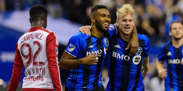 MONTREAL, QC - MARCH 12: Anthony Jackson-Hamel #24 of the Montreal Impact celebrates his goal with teammate Kyle Bekker #18 during the MLS game against the New York Red Bulls at the Olympic Stadium on March 12, 2016 in Montreal, Quebec, Canada. The Montreal Impact defeated the New York Red Bulls 3-0. (Photo by Minas Panagiotakis/Getty Images)