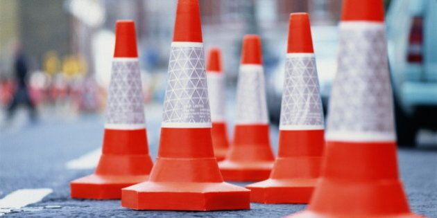Traffic cones in middle of urban street, close-up
