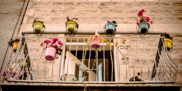 A balcony in the Mile End neighbourhood of Montreal is decorated with colourful potted plants. The punch of colour is a welcome sight in this urban setting, a bit of nature and colour in the city.