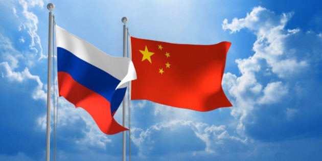 Flags from Russia and China flying side by side for important talks.