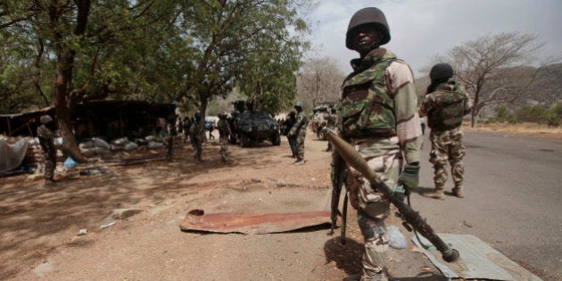 FILE - In this Wednesday April 8, 2015 file photo, Nigerian soldiers man a checkpoint in Gwoza, Nigeria, a town newly liberated from Boko Haram. Nigeriaâs president has exaggerated the militaryâs success against Boko Haram, say officials in northern Nigeria in response to an American commanderâs testimony that the Islamic extremist group still holds territory. (AP Photo/Lekan Oyekanmi, File)