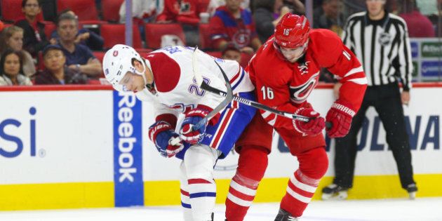 Nov 18, 2016; Raleigh, NC, USA; Montreal Canadiens defensemen Nathan Beaulieu (28) battles for the puck with Carolina Hurricanes forward Elias Lindholm (16) during the second period at PNC Arena. Mandatory Credit: James Guillory-USA TODAY Sports