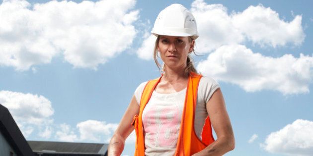 Female construction worker with machinery