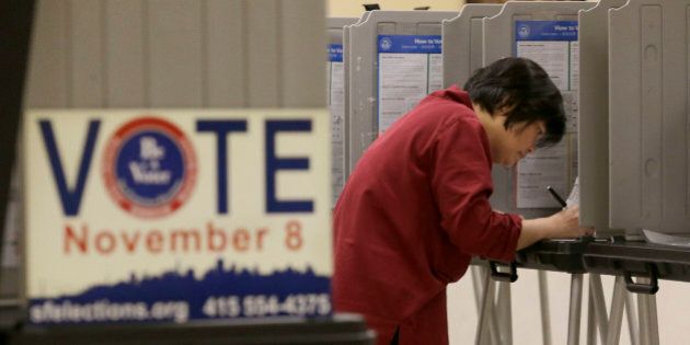 Shu Chu, originally from Taiwan, votes at City Hall in San Francisco, Tuesday, Nov. 8, 2016. (AP Photo/Jeff Chiu)