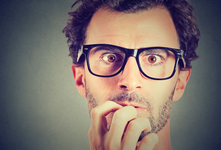 60296738 - anxious stressed young man looking at camera