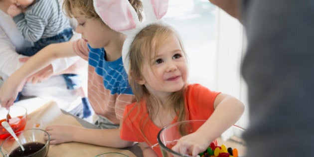Cute daughter in bunny ears smiling up