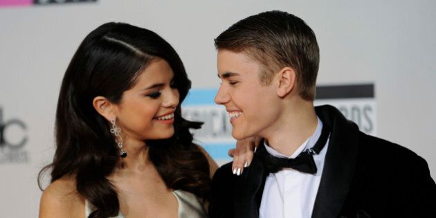 Selena Gomez, left, and Justin Bieber arrive at the 39th Annual American Music Awards on Sunday, Nov. 20, 2011 in Los Angeles. (AP Photo/Chris Pizzello)