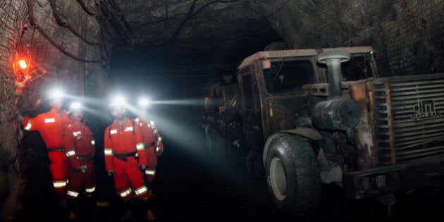 Contractors stand next to a machine while working at the underground Glencore Plc Bracemac-McLeod zinc mine in Malartic, Quebec, Canada, on Friday, Sept. 11, 2015. After tumbling in the rankings in recent years, Quebec has re-established itself as one of the world's most attractive mining jurisdictions, according to the Fraser Institute's annual survey of the mining industry. Photographer: Valerian Mazataud/Bloomberg via Getty Images