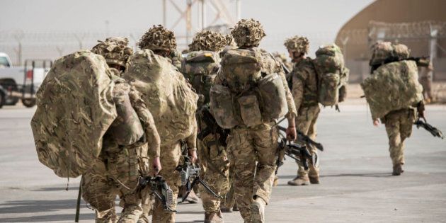 Some of the last British troops head towards the flight line as they prepare to leave Camp Bastion, Helmand Province, Afghanistan, as UK and Coalition forces carry out their Tactical Withdrawal finally leaving the base and handing it over to Afghan National Army.