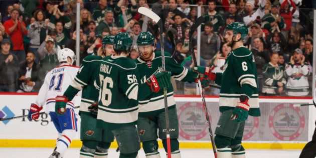 ST. PAUL, MN - DECEMBER 22: (L-R) Mikael Granlund #64, Erik Haula #56, Jason Pominville #29, and Marco Scandella #6 of the Minnesota Wild celebrate after scoring a goal against the Montreal Canadiens during the game on December 22, 2015 at the Xcel Energy Center in St. Paul, Minnesota. (Photo by Bruce Kluckhohn/NHLI via Getty Images)